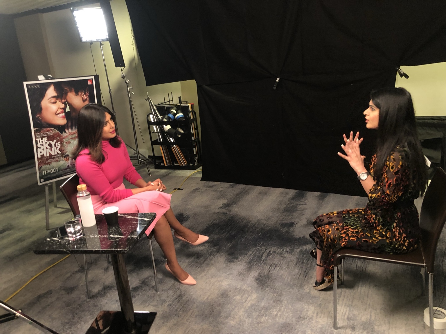 Aditi interviewing actress and producer Priyanka Chopra Jonas in a studio.